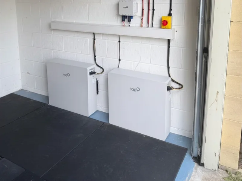 Two Fox ESS home battery units installed in a garage alongside the inverter