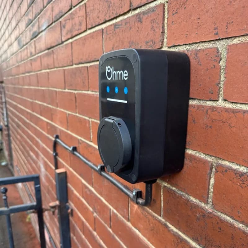 Ohme ePod compact EV charger installed on a brick wall