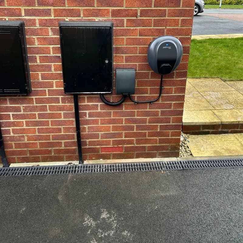 Pod Point EV charger installed on the side of a new-build home