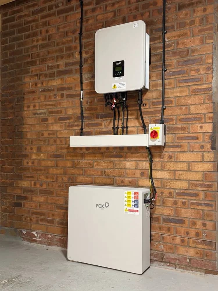 Fox ESS inverter and battery storage unit installed on a brick wall